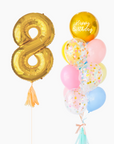 A balloon arrangement featuring a gold-colored number '8' balloon, along with pink and blue balloons, tied together with ribbons.