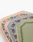 Set of four hexagonal notepads with floral patterns on a white background