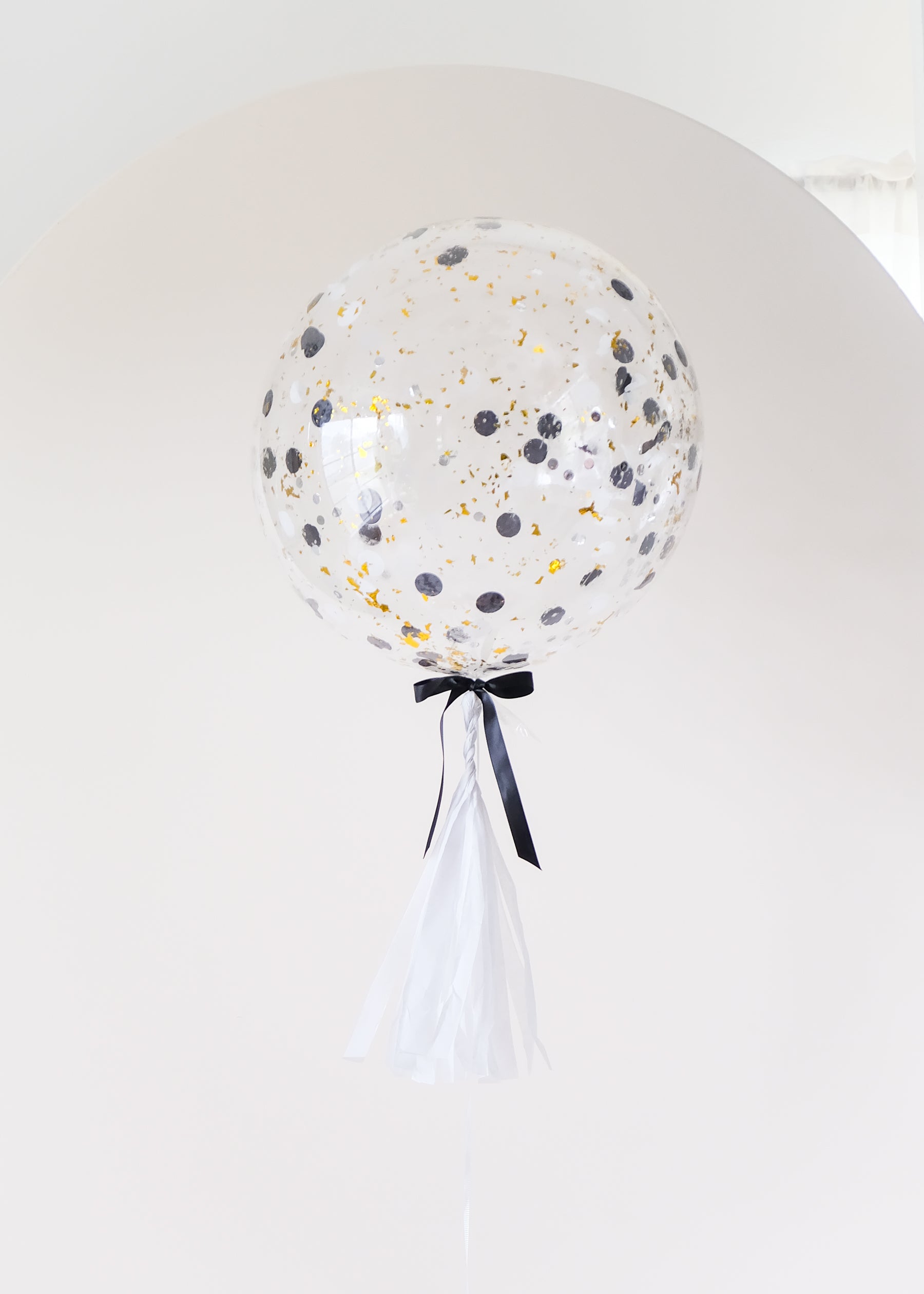 round confetti filled balloon with tassel