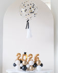 2026 mini balloons with a round confetti balloon centerpiece