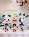 Halloween-themed balloons with cartoon character faces on a table.
