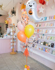Decorative balloons with a ghost design in a store setting