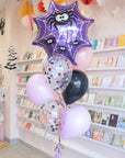 Halloween-themed balloon set with spider web design in a store setting