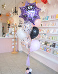 Decorative balloons with spider design in a store setting