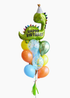 A balloon bouquet featuring a green dinosaur-shaped balloon with a 'Happy Birthday' message, surrounded balloons in various colors, tied together with a bow and tassel.