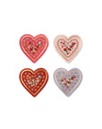 Four decorative heart-shaped items with floral patterns on a white background