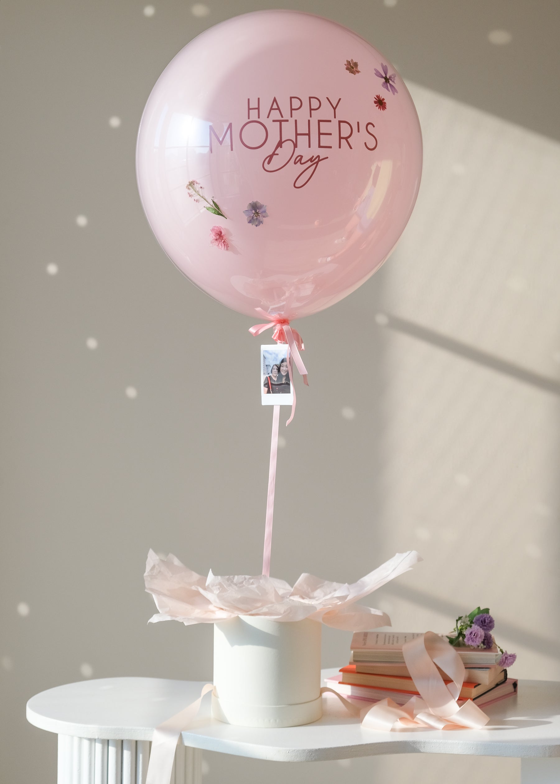 Pink "Happy Mother's Day" balloon with an instant photo of a mom and daughter