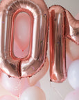Close up of rose gold "MOM" balloons with floral decals