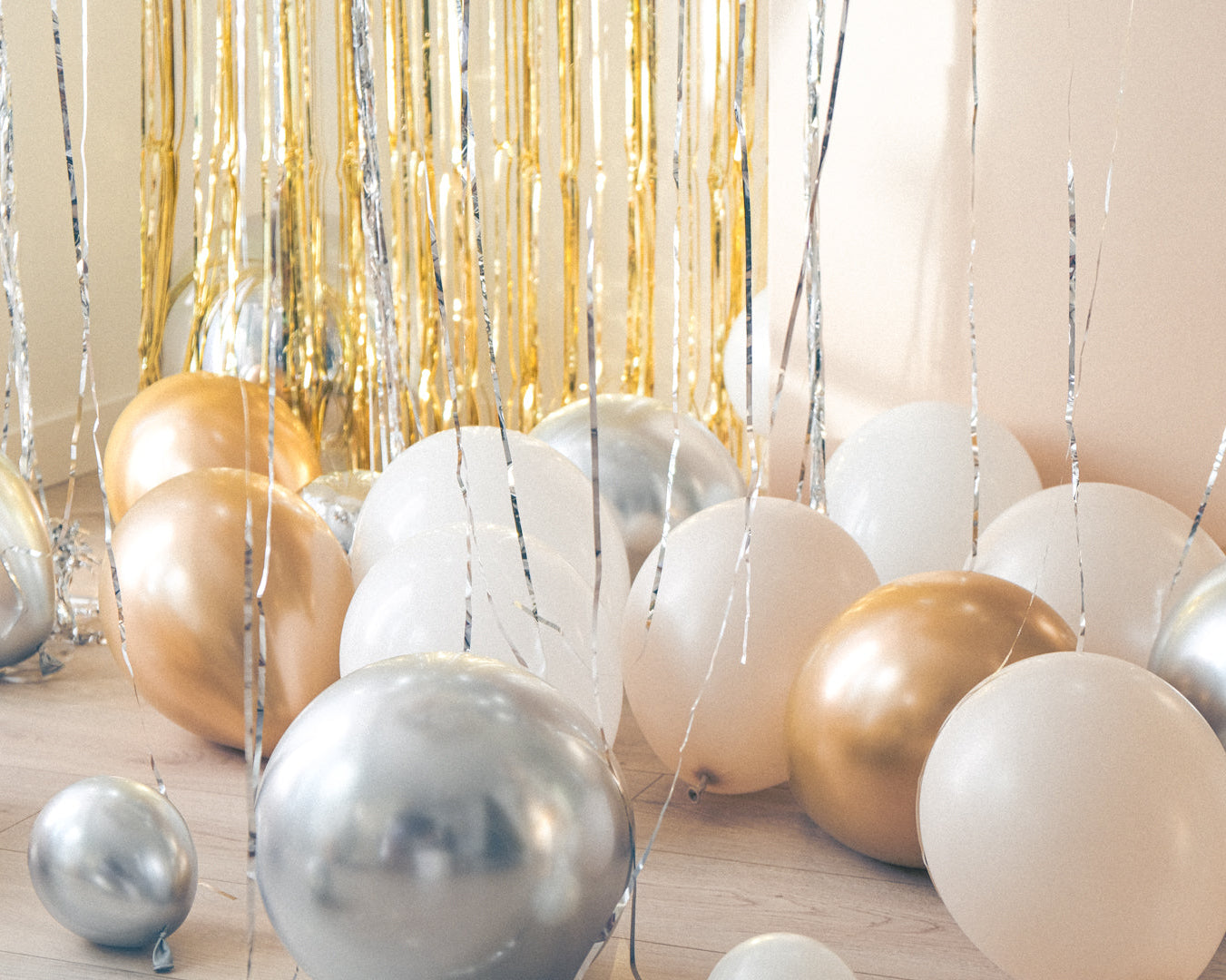 white gold cream silver balloons on the floor