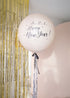 Cream round balloon with black bow and silver metallic tinsel. Text reads "3..2..1.. Happy new Year!" with gold tinsel and cream backdrop