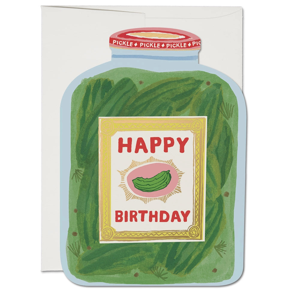 A greeting card with a pickle-themed design, featuring a cartoon image of a pickle jar with 'Happy Birthday' and a pickle inside. The card is blank inside and made from heavyweight card stock.