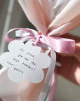 close up of gift tag with ribbon bow