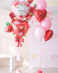 A balloon set with a double stack of floral heart balloons in various shades of red and pink, with bows and mini hearts, designed for Valentine's Day.