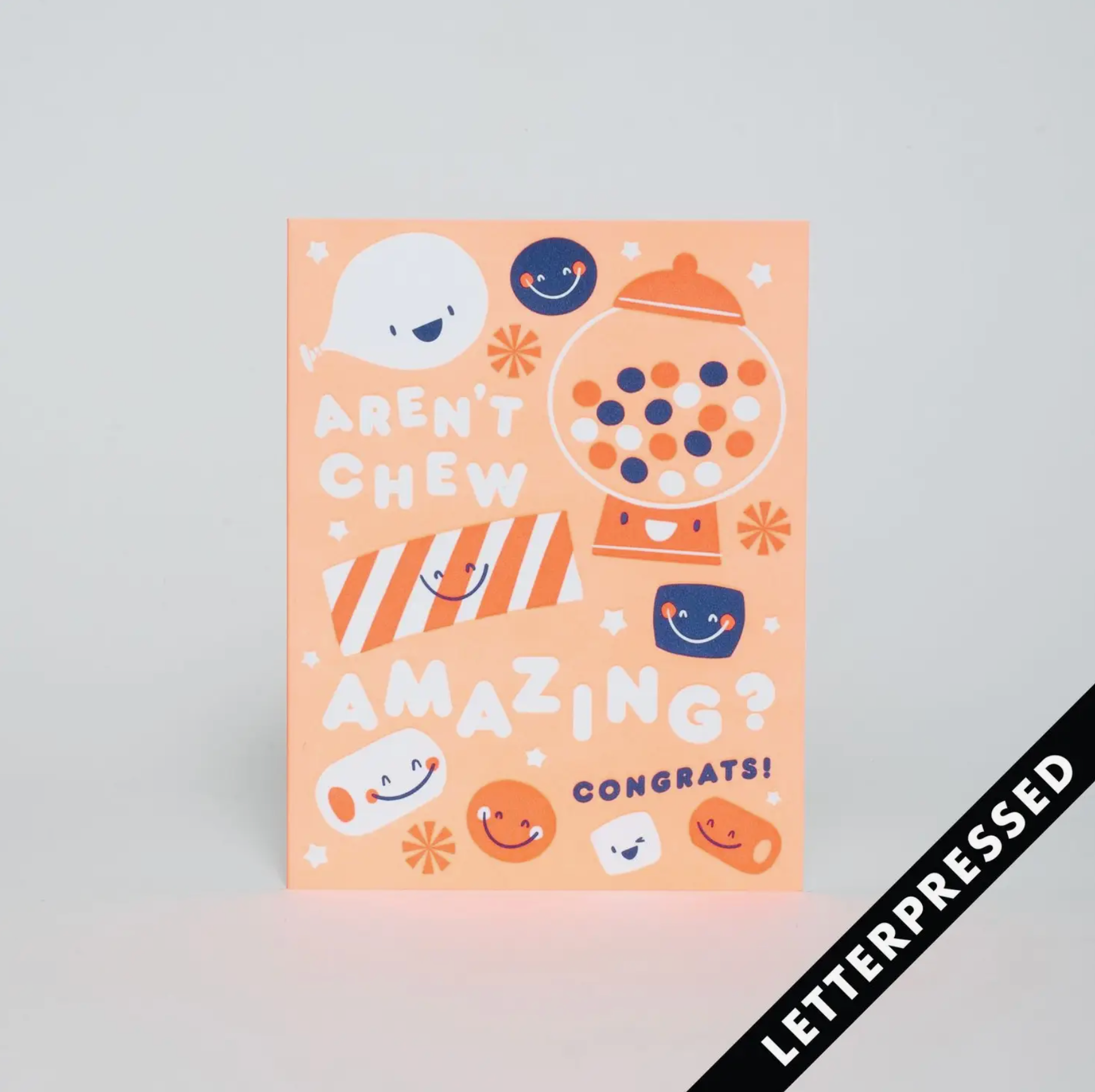A congrats card with a bubble gum theme, featuring text and illustrations such as a smiling face, a dog, and a party hat. The card is primarily orange and has a 'Congrats!' message.