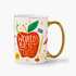 A white porcelain mug with a colorful illustration that includes an apple, stars, and text that reads 'World's Best Teacher', with metallic gold accents.