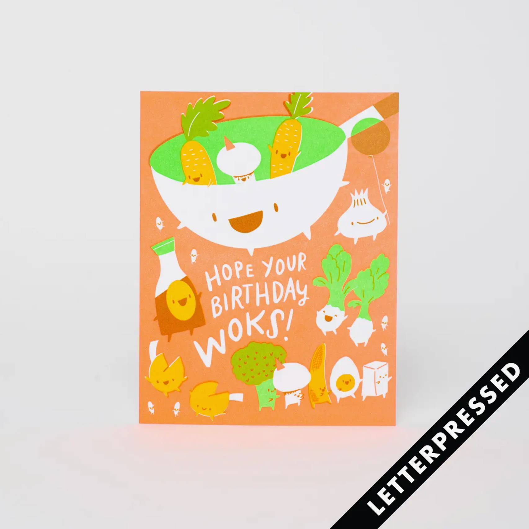 Orange birthday card with vegetables and a wok