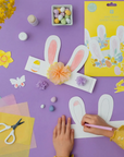 Child coloring the paper bunny ears