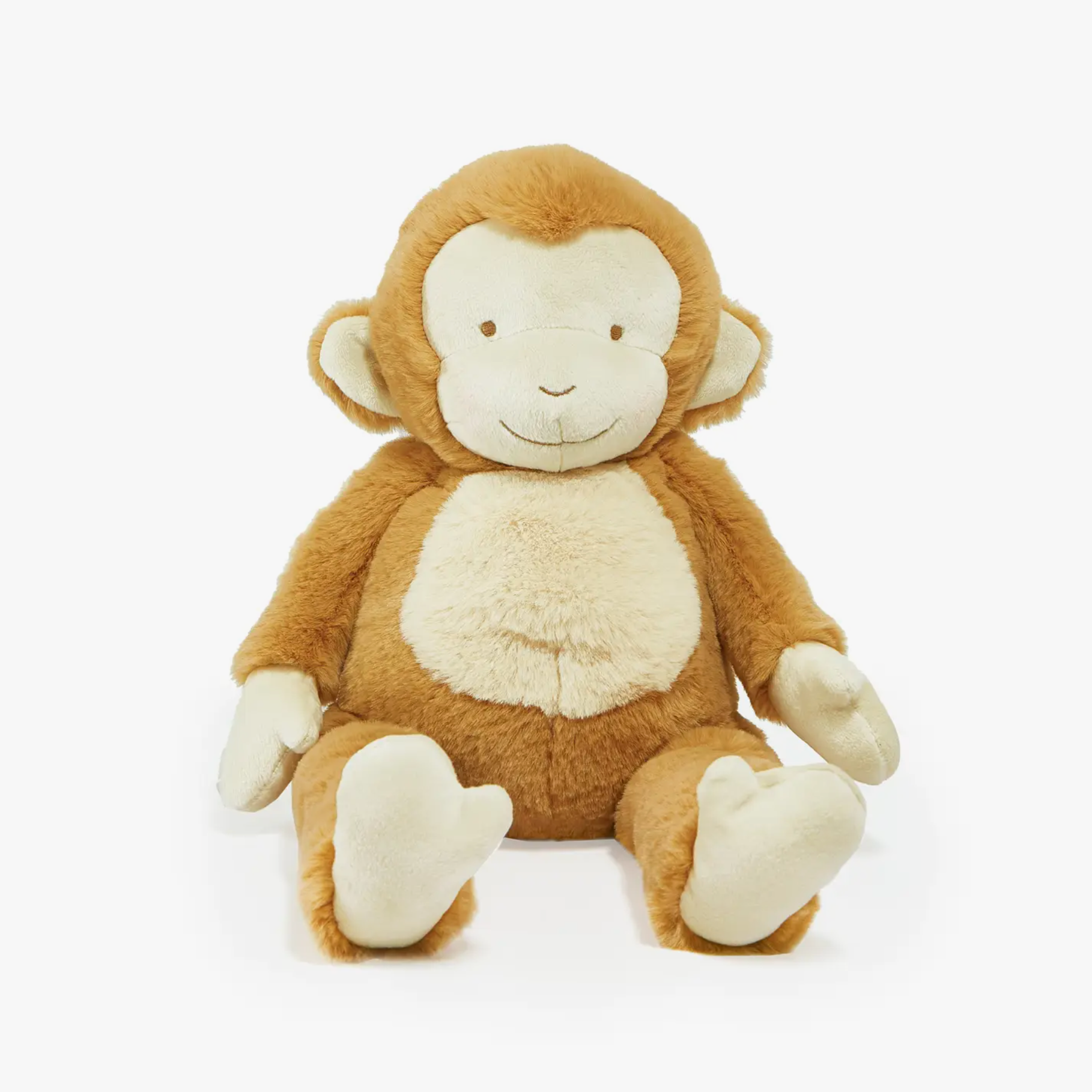 A plush monkey toy with a smiling face, made of soft brown fabric, seated with its hands resting on its knees.