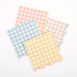 A set of four pastel gingham small napkins in coral, blue, yellow, and pink, displayed on a white background.