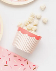 a food cup with candies spilling out on a table