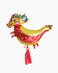 A multicolored balloon designed to resemble a dragon, with red tassel details.