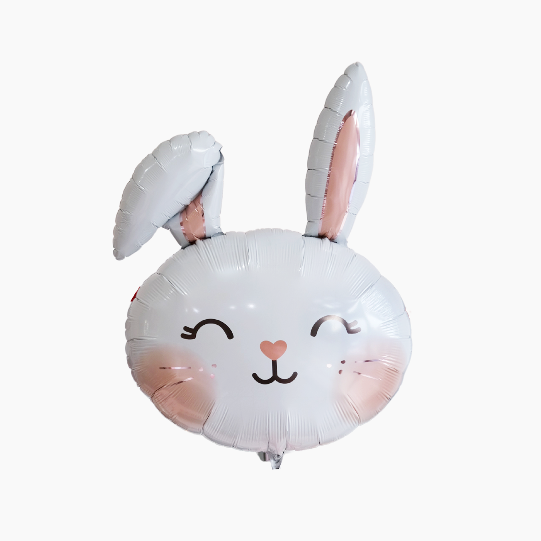 A white balloon in the shape of a rabbit with pink details and a smiling face.