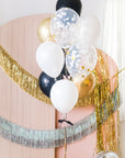 A selection of balloons including standard, medium, and large latex balloons in various shades of gold, white, and black, featuring confetti and ribbon details, helium-filled for indoor use.