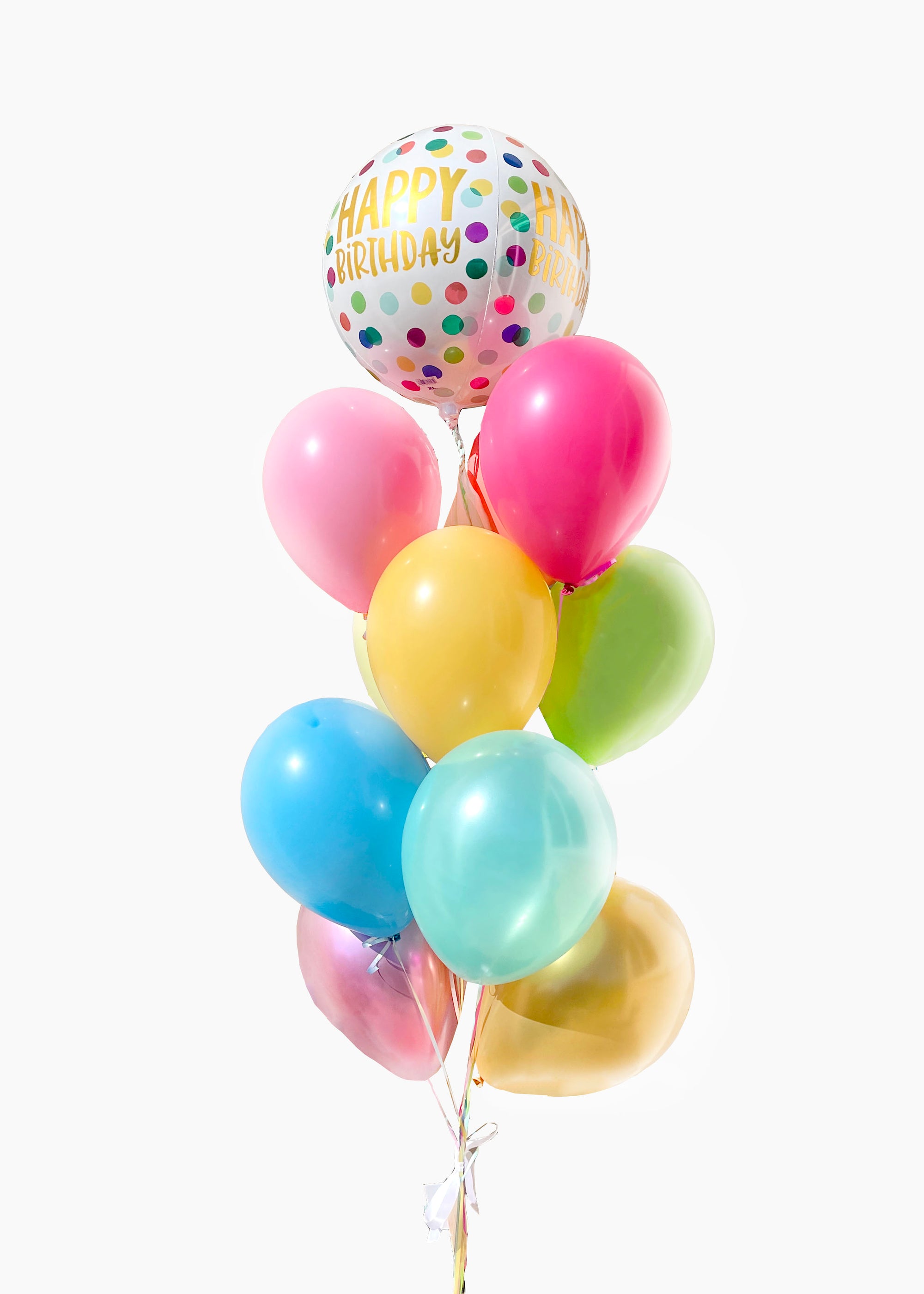 A bouquet of colorful balloons including shades of pink, blue, green, yellow, and gold, with a round happy birthday balloon on top.